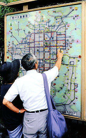 Man reads transit route map in Kyoto. Japan.