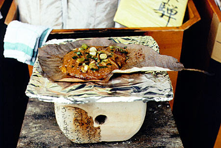 Cooking a traditional local Takayama dish on a brazier. Japan.