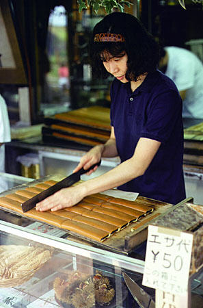 Cutting pastries into bite size pieces. Japan.