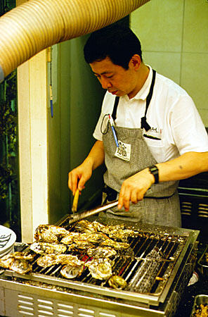 Chef prepares oysters in Miya Jima. Japan.