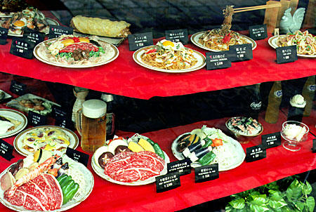 Plastic food serves as a menu in a Nara restaurant window. Japan.