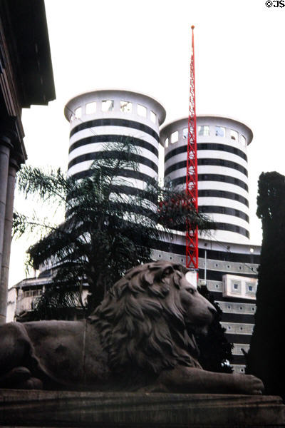 Facade of Aga Khan building contrast stone lion of public library in Nairobi. Kenya.