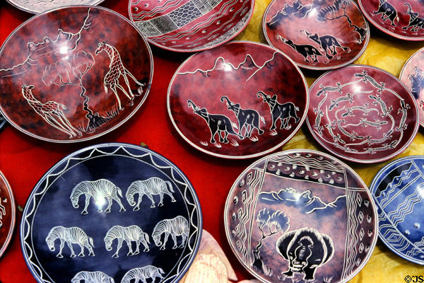 Painted clay dishes with animal themes at a crafts market near Nairobi. Kenya.