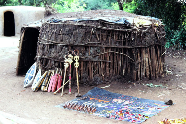 Crafts in front of a traditional tribal hut in Bomas near Nairobi. Kenya.