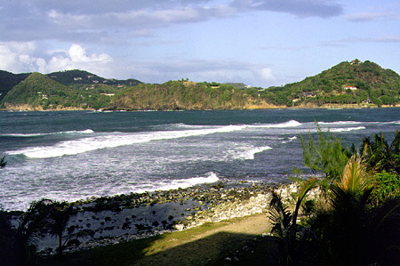 Waves off Pigeon Island National Park with Gros Islet in the distance. St Lucia.