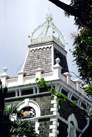 The crown and crest on the tower of Government House which can be seen from Castries. St Lucia.