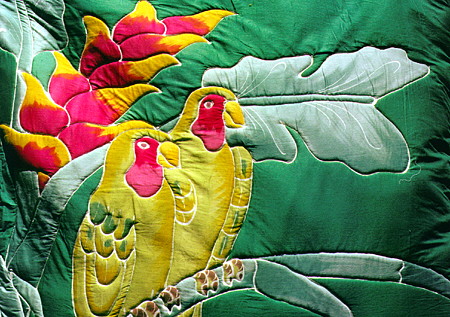 Parrots and heliconia on a Caribelle Batik designed wall hanging. St Lucia.