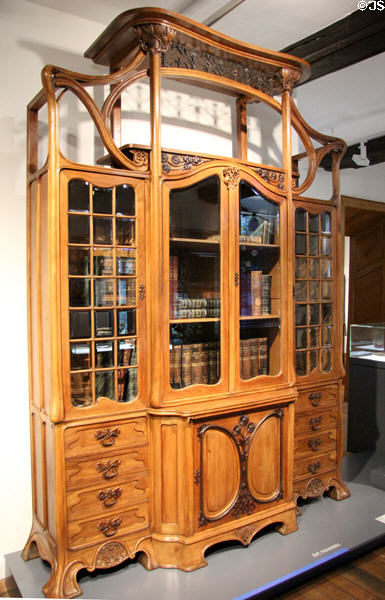 Walnut & oak bookcase (early 20thC) in Art Nouveau style at National Museum of History & Art. Luxembourg, Luxembourg.
