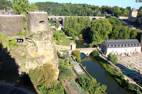 Ancient fortifications & Alzette river flowing past St.Jean Du Grund Church seen from Le Bock. Luxembourg, Luxembourg.
