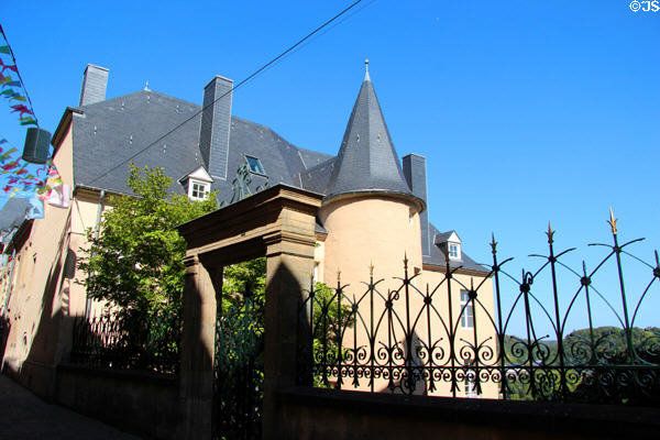 Historic building with turrets & ornate ironwork fence in historic core of city. Luxembourg, Luxembourg.