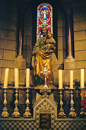 Saint & candle sticks within Monaco Cathedral. Monaco.