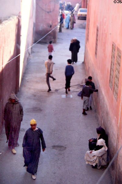 Narrow street with pedestrians. Marrakesh, Morocco.