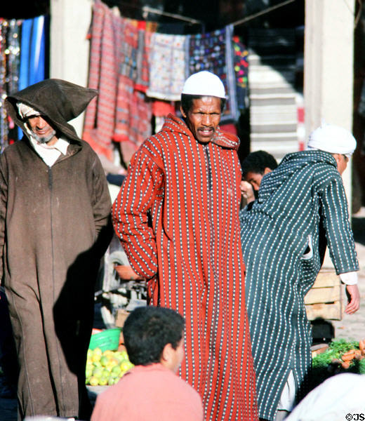 Men in traditional dress in souk. Erfoud, Morocco.