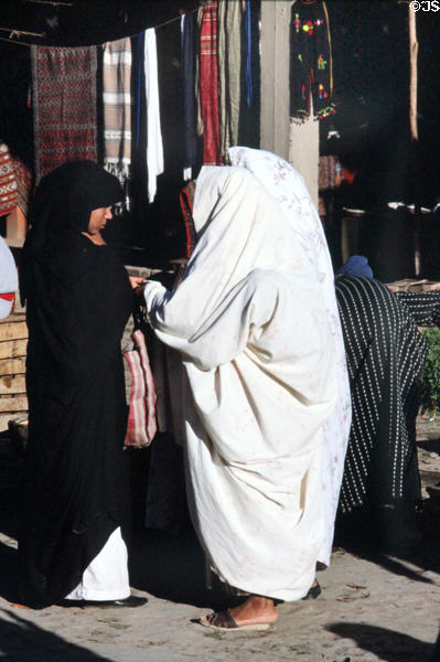 Women in traditional dress in souk. Erfoud, Morocco.