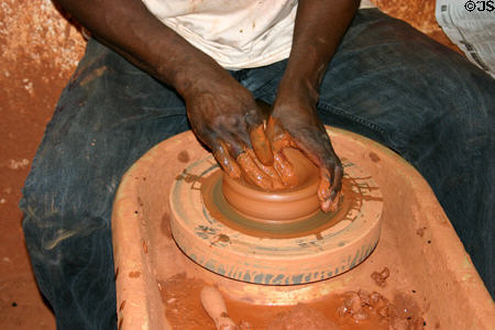 Artisan throws pottery at pottery center. Trois Islet, Martinique.