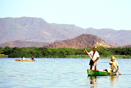 Fishermen in a canoe on Lagoon Coyuca. Mexico.