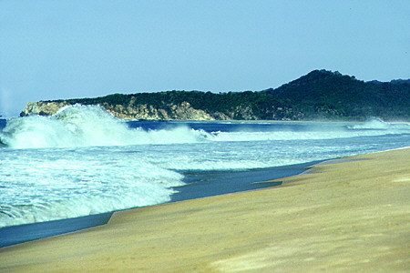 Crashing waves on beach at Manialtepec. Mexico.
