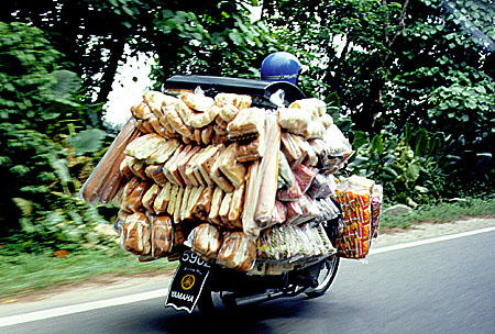 Bread delivery by motorbike in Kuala Lumpur. Malaysia.