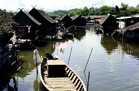 Homes and canoe in Mengkabong water village. Malaysia.