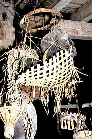 Heirloom enemy heads hang from longhouse rafters for Sarawak tribes who were once headhunters in typical for Borneo. Malaysia.
