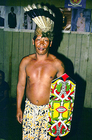 Dancer with feather headdress and shield from Ugat longhouse in Sarawak. Malaysia.