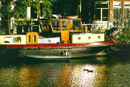 Houseboat on Zwanenburgwal near opera. Amsterdam, Netherlands.