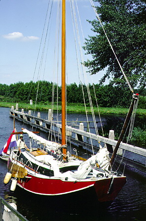 Sailboat docked in canal South of Giethoorn. Giethoorn, Netherlands.