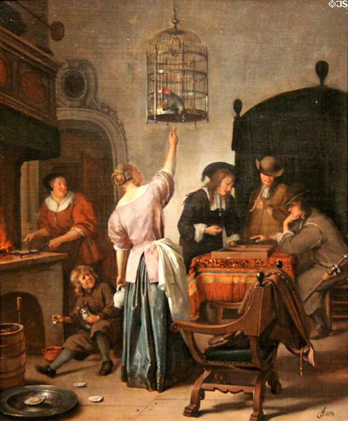 Interior with woman feeding a parrot (aka The Parrot Cage) painting (c1660-70) by Jan Steen at Rijksmuseum. Amsterdam, NL.