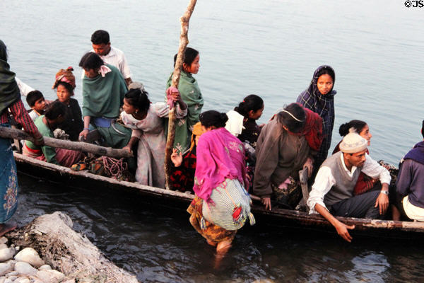 Nepalese in Chitwan National Park prepare to cross river. Nepal.