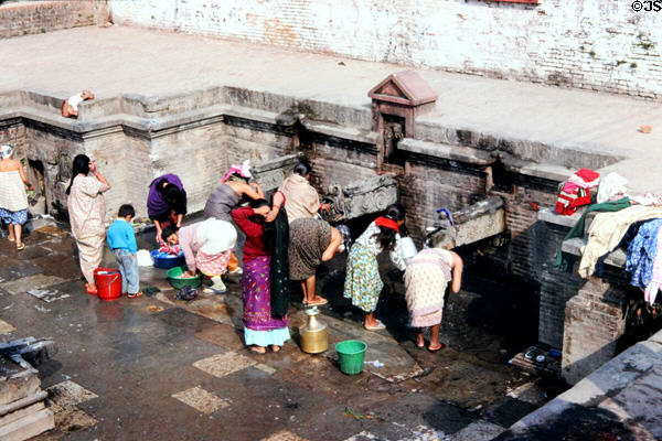 Washing at public fountains near Kumbeshvara Mandir (temple) in Patan (Lalitpur), Katmandu. Nepal.