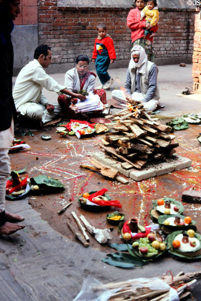 Couple makes an elaborate offering at Kumbeshvara Mandir (temple) in Patan (Lalitpur), Katmandu. Nepal.