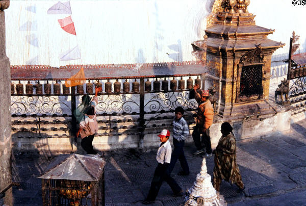 People using prayer spindles at Swayambhunath Buddhist Temple, Katmandu. Nepal.