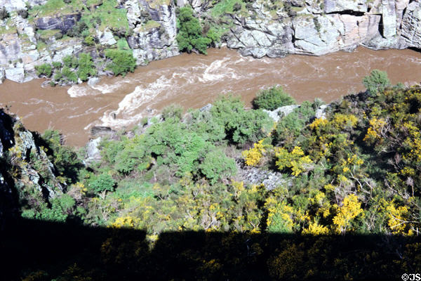 Looking down on flowing water from Taieri Gorge Rail Road. New Zealand.