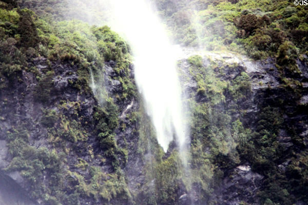 Waterfall blows upwards in the constant winds of Milford Sound. New Zealand.