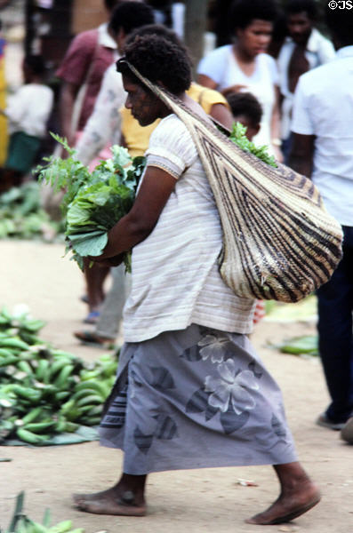 Woman carrying her purchases from her head at a market in Port Moresby. Papua New Guinea.