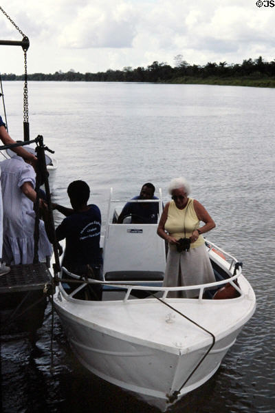 Tourists transfer to tender to go ashore along Sepik River. Papua New Guinea.