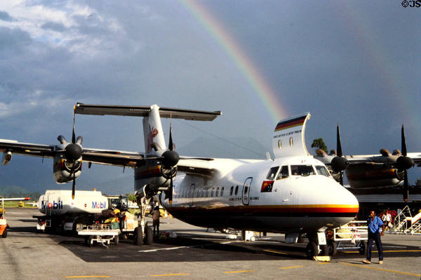 Rainbow forms over a Canadian-made Dash 7, at Mount Hagen airport. Papua New Guinea.