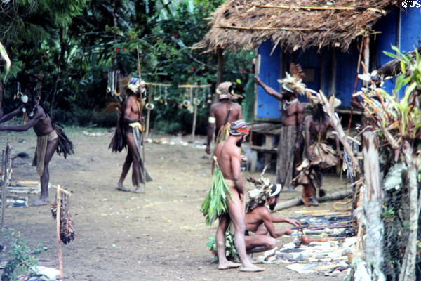 Chimbu village prepares to perform traditional rituals and dances for a group of travelers. Papua New Guinea.