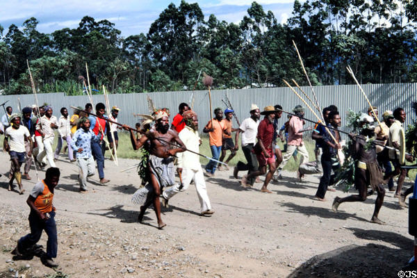 War party armed with spears on road near Banz. Papua New Guinea.