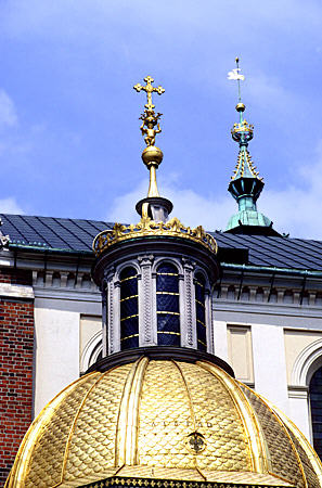 Golden cross adorns golden dome of Wawal Cathedral in Krakow. Poland.