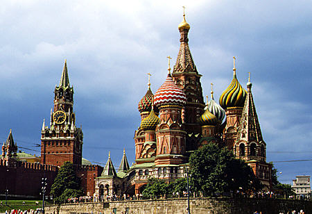 St Basil's church in Moscow with towers & walls of Kremlin at left. Russia.