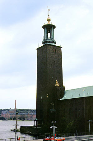 Tower on south east corner of Stockholm Town Hall features three gold crowns of Swedish coat of arms. Sweden.