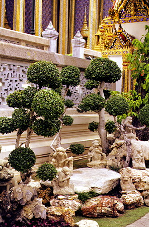Bonsai trees and monkey sculptures at the Grand Palace in Bangkok. Thailand.