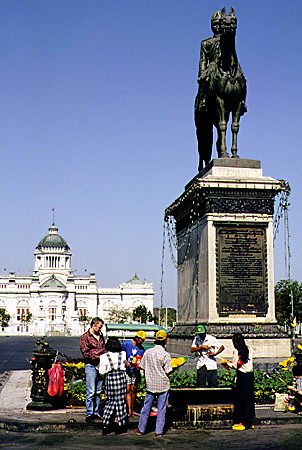 Equestrian statue of the King with the Throne Palace in the distance, Bangkok. Thailand.