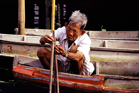Fixing the boat on the khlong (canal) in Bangkok. Thailand.