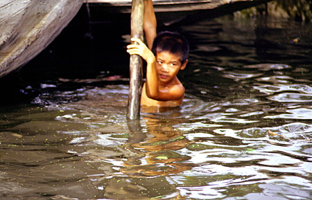 Child swimming in the khlong (canal), Bangkok. Thailand.