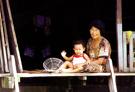 Mother and son at their home along the khlong (canal), Bangkok. Thailand.