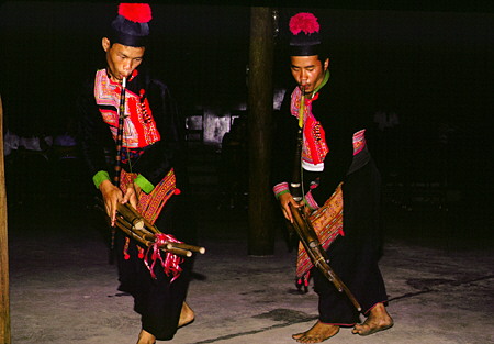 Meo tribal musicians wearing traditional dress playing Khaen reed pipes in Chiang Mai. Thailand.