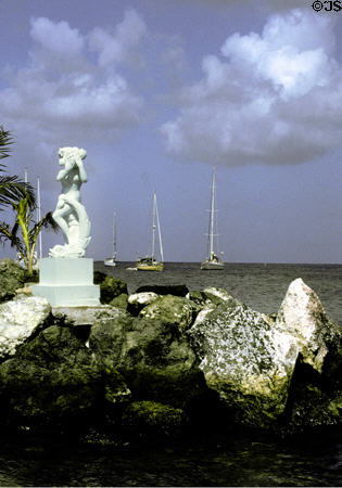 Sculpture on rocks in sea at Coco Reef Hotel. Trinidad and Tobago.