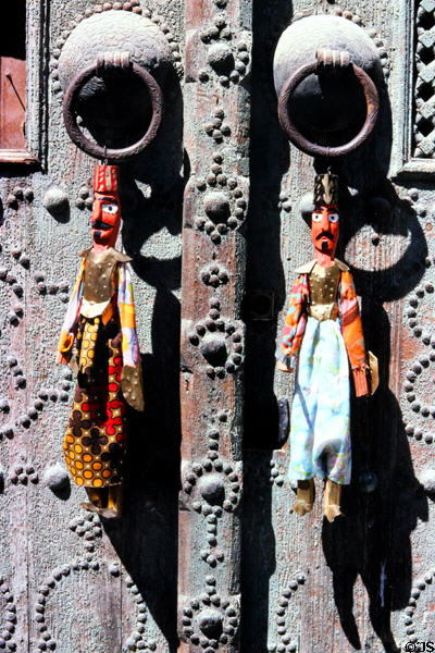 Islamic puppets hung on door handles in Medina. Tunis, Tunisia.